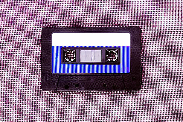 Old Audio Tape Cassette on the Textile Background closeup