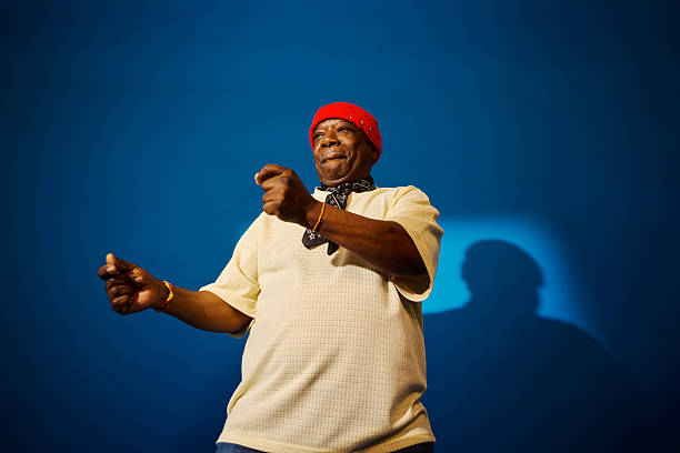 Energetic senior adult man expressing joy and vitality on a blue studio background