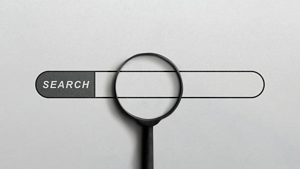 A minimalist image featuring a black magnifying glass placed over an empty search bar on a textured background, representing web searching, data analysis, and online investigation