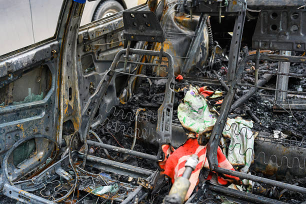 flames and fire inside the passenger compartment of the car set on fire during the revolt of the rioters in the city