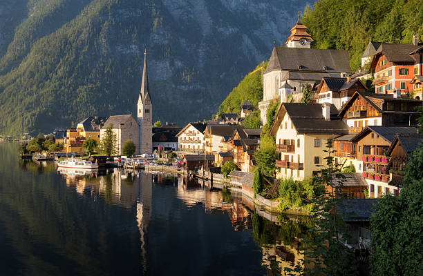 The iconic village Hallstatt, Austria, in early morning light. A gorgeous landscape with the mountains in the background of the houses and reflections in the water of the lake