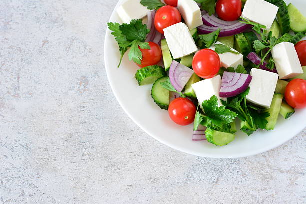 Fresh Mediterranean Salad with Feta, red onion and Vegetables top view copy space