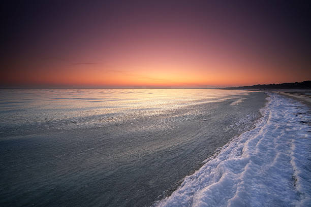 Frozen Baltic Sea beach in Babie Doy at sunset, Gdynia. Poland