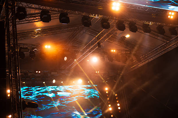 Professional stage lights and video wall on the summer night concert.
