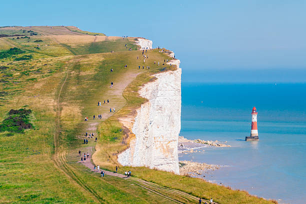 White cliffs in England at the ocean with a light house