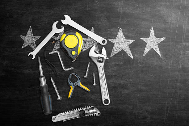 A collection of hand tools arranged in front of a chalkboard with five drawn stars, symbolizing top-rated repair services, professional maintenance, and high customer satisfaction. Concept image for quality workmanship, reliability, and trusted technical service.