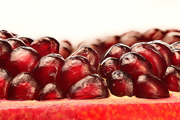 A close up of a red pomegranate fruit with a lot of seeds