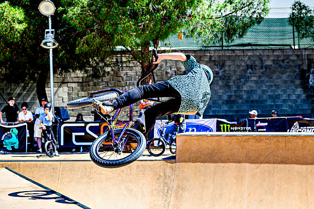 Igualada, Barcelona May 17, 2025: A young man practicing BMX and performing tricks at the skatepark