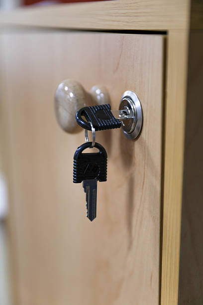 Close Up Of A Metal Lock With A Key Inserted In A Wooden Cabinet Door, Representing Security, Privacy, Access Control, Storage Protection, And Everyday Home Or Office Organization.