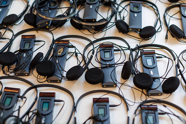 Headsets arranged neatly on a table for a conference or event in a modern venue