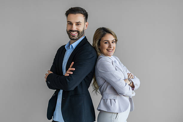 istock Confident Business Duo Back-To-Back Professionals Smiling In Studio Portrait 2258367639