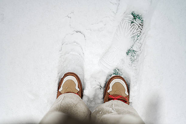 woman sculpts snowballs in red gloves
