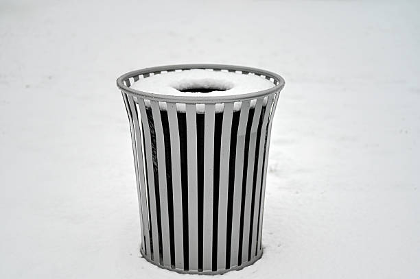 Vertical shot of a dirty tall kitchen trash can with black trash bag and lid open.  Close-up of the top half of the trash can.