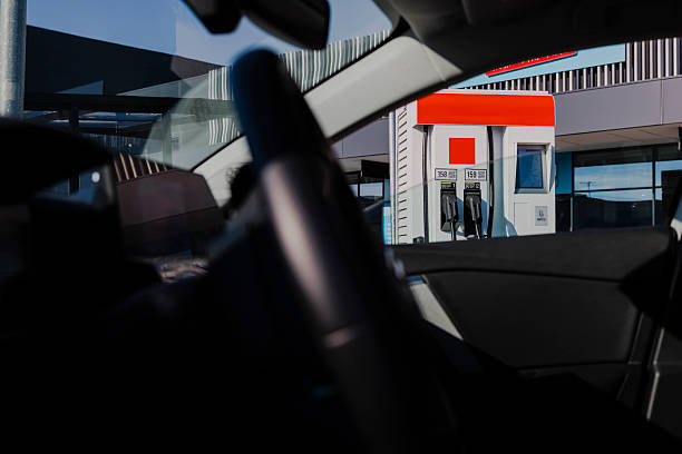 Contemporary gas station with multiple fuel dispensers, and visible safety equipment including fire extinguishers. The station appears well-maintained and ready for customers.