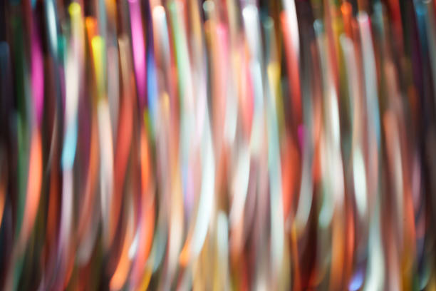 Multicolor vertical light trails with soft motion blur and glowing streaks on a dark background. Dynamic abstract backdrop for technology, music, nightlife, events, and modern design.