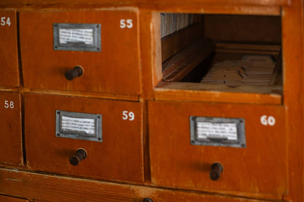 Wooden card catalog with an open drawer filled with index cards