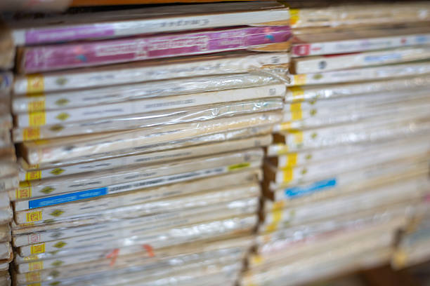 Many old books with worn covers and plastic wrap showing a collection on a shelf