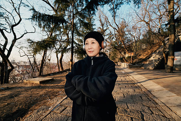 Woman in Black Jacket Standing in Outdoor Path