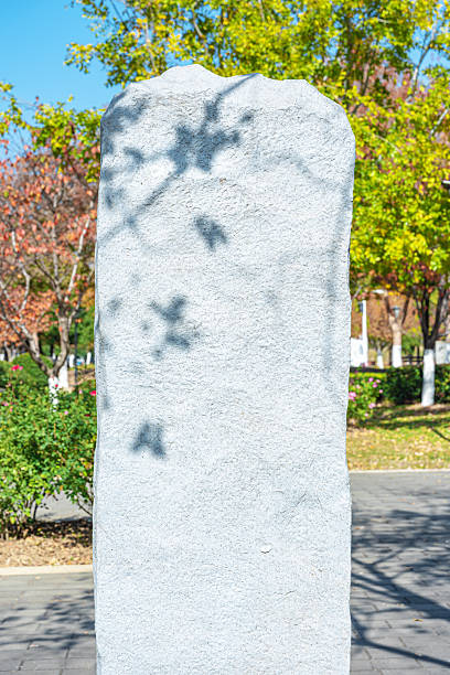 Blank stone slate standing in the lush green garden