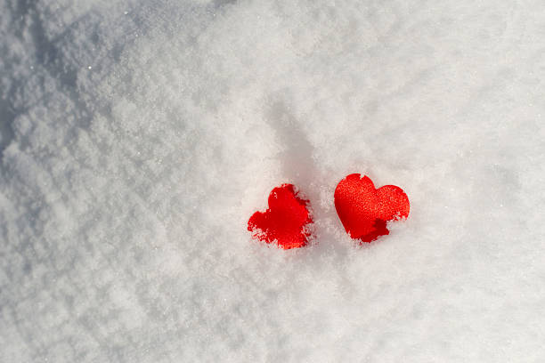 Two Red Hearts in Snow. Valentines day card.