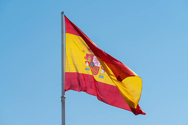 Spanish National Flag Waving Against Blue Sky