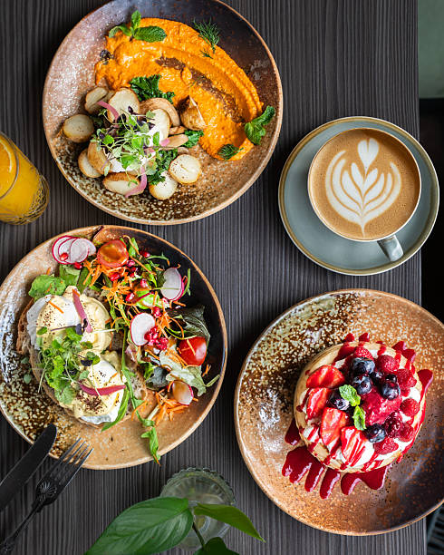 Top View of Healthy Brunch Table with Pancakes Salad Eggs and Coffee.
