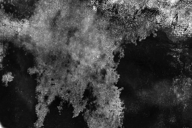 A weathered surface featuring irregular stains, smudges, and aged paint. Ideal for backgrounds, textures, and design concepts conveying age, decay, and mystery. Grunge Texture Design Element.