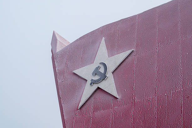 Frost-covered red star with hammer and sickle emblem on a socialist monument in Beijing, China, symbolizing CCP ideology and revolutionary heritage.