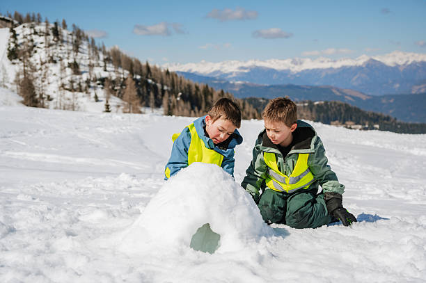 Happy twins playing in an Alpine resort.