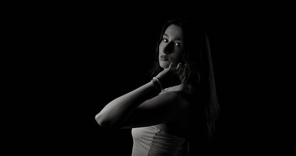 Photo of an angry young woman. She has put her fists up and is ready for the fight..