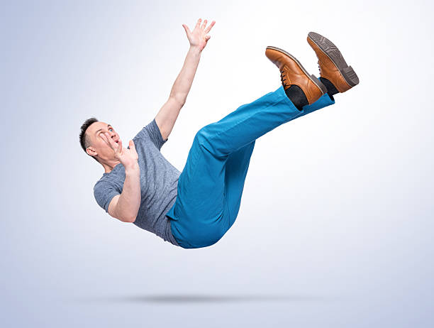 istock Man falling in mid air isolated on white background as a metaphor of failure, career collapse, financial crisis, risk, mistake and loss of control. Concept of setback, instability and sudden downfall 2258453771