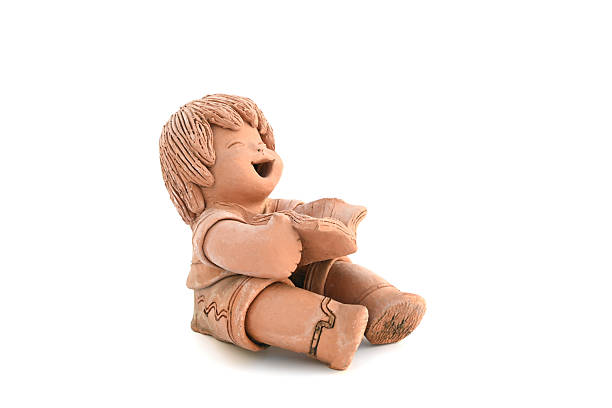 Little girl sculpts a toy from clay with enthusiasm