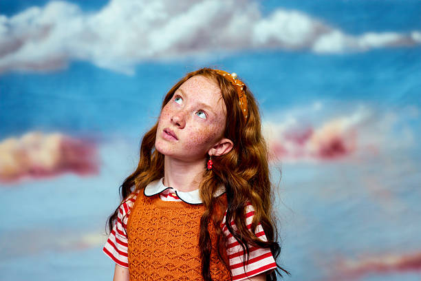 close-up portrait of a girl against the blue sky