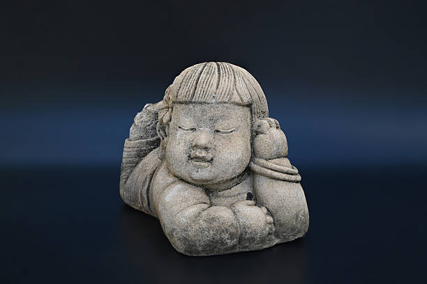 Small statue of angel on tombstone