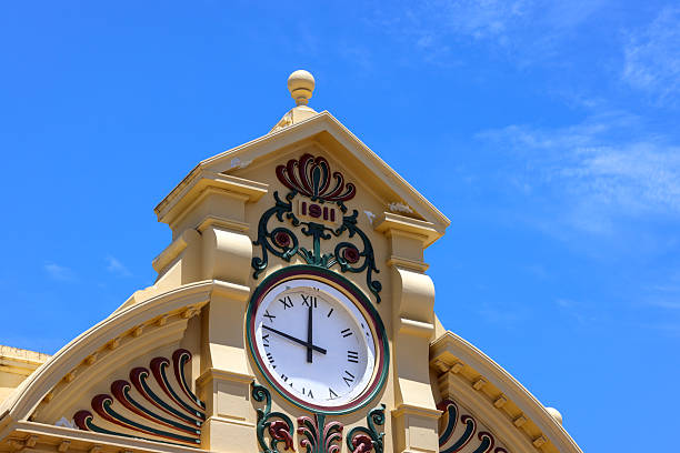 Ornate building exterior facade with large clock, in typical Edwardian era style, late 19th early 20th century.  1890-1899, 1900-1909. History, heritage, architecture. Copy space