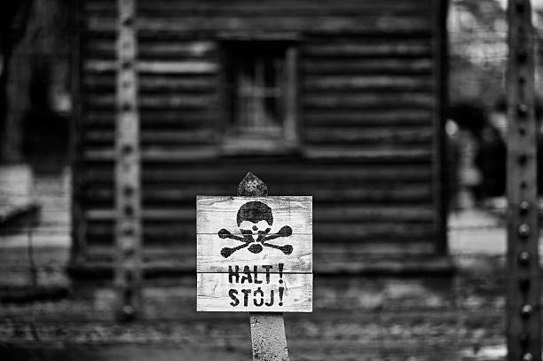 Warning sign with skull and crossbones at Auschwitz Birkenau