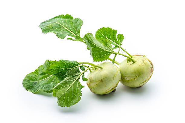 Fresh kohlrabi with green leaves on isolated white background. Studio shot. High angle view.