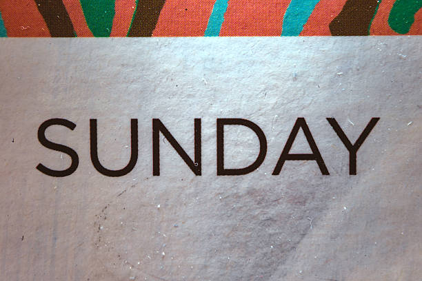 Macro composition of the inscription Sunday on a dirty sticker.
