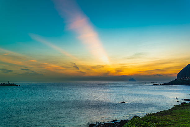 Witness the serene pre-dawn glow at Keelung Waimushan, Taiwan, with neon-hued clouds and calm waves. Filmed in 2025, this summer morning features blue-orange skies and vibrant colors.