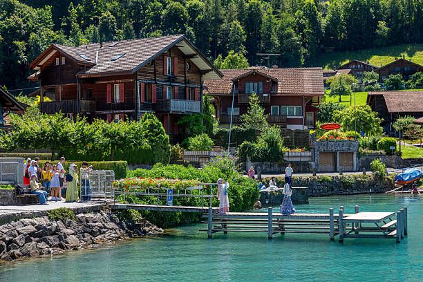 Iseltwald, Switzerland - July 18, 2025: Tourists wait to be photographed on the pier in Iseltwald, famous for its appearance in a Bollywood film.