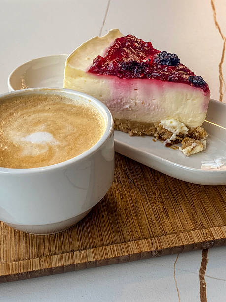 Cappuccino and cheesecake slice at sidewalk cafe