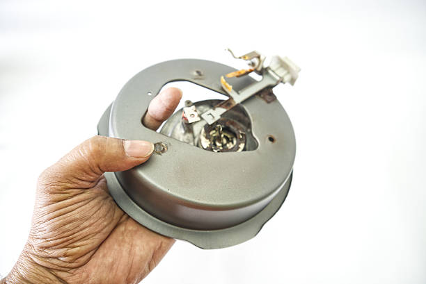 Senior computer technician (50+) performing computer maintenance. Concept: disassembly, cleaning, repair, and restoring the computer to full working condition