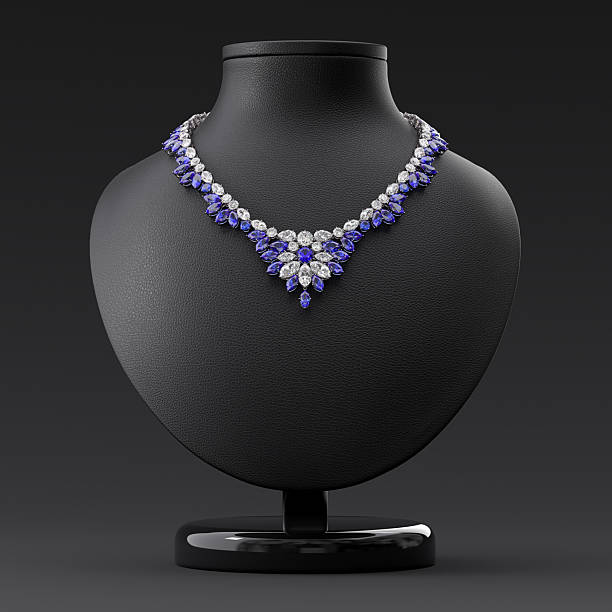A luxurious necklace of diamonds and blue sapphires on a leather bust stand. Frontal view. Jewelry showcase. 3d rendering.