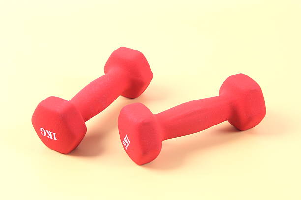 Red dumbbell on yellow background