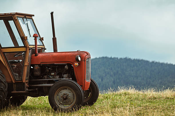 Canada Prince Edward island.  old tractor used as lawn decoartion