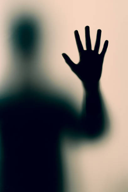 Killer. Gun in hand. Silhouette of man