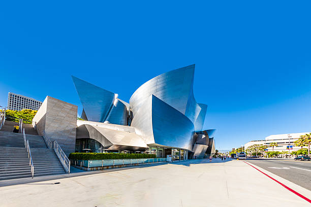 Los Angeles, California - December 4, 2024: View of the Walt Disney Concert Hall with pedestrians crossing the street, showcasing urban life and modern architecture in Los Angeles.