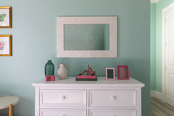 White wooden dressing table with an oval mirror and two small storage drawers, offering a clean and elegant furniture piece for interior design concepts