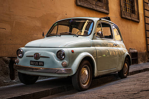 Florence, Italy - September 10 2023 White shiny classic car Fiat 500 parked in the centre of Florence