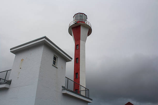 Cape Forchu - November, 2025: Shot on a beautiful cloudy day at the Cape Forchu Lighthouse, located near Yarmouth. Because shipwrecks were so common in this area, they built the original lighthouse (of which the light station was replaced in 1962) in 1874. After Yarmouth became Canada's second largest port of registry.